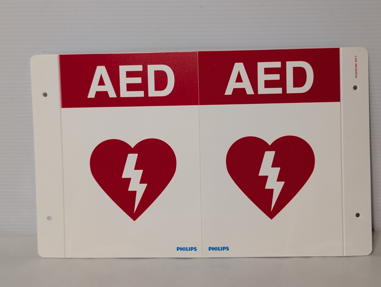 Philips 989803170921 – AED Wall Sign, Red, 9″ H x 6.1″ D, Versatile Mounting