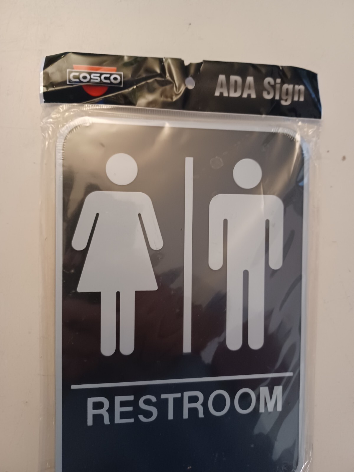 Cosco ADA RESTROOM Self Adhesive Sign with Braille 9″ X 6″