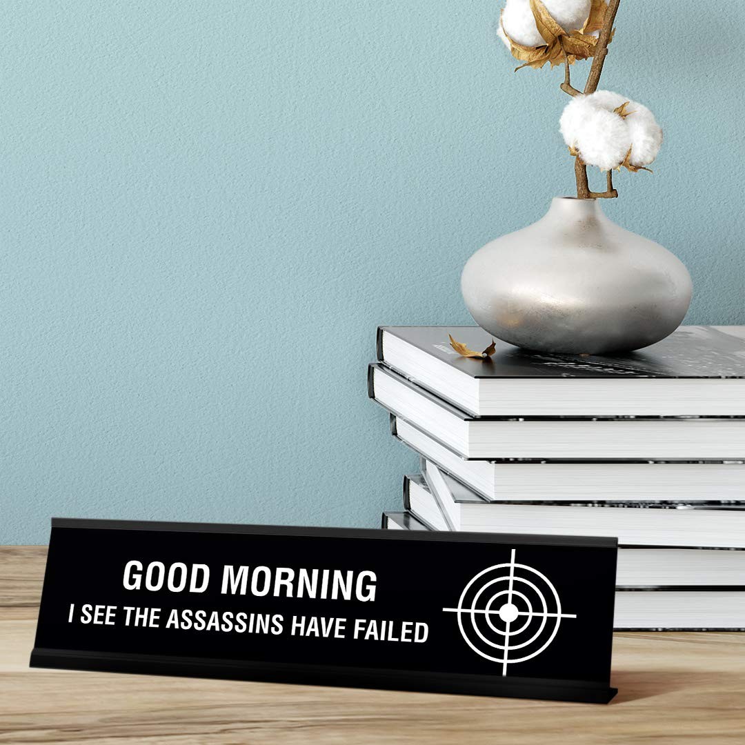 Good Morning I See The Assassins Have Failed Desk Sign, novelty (2 x 8″)