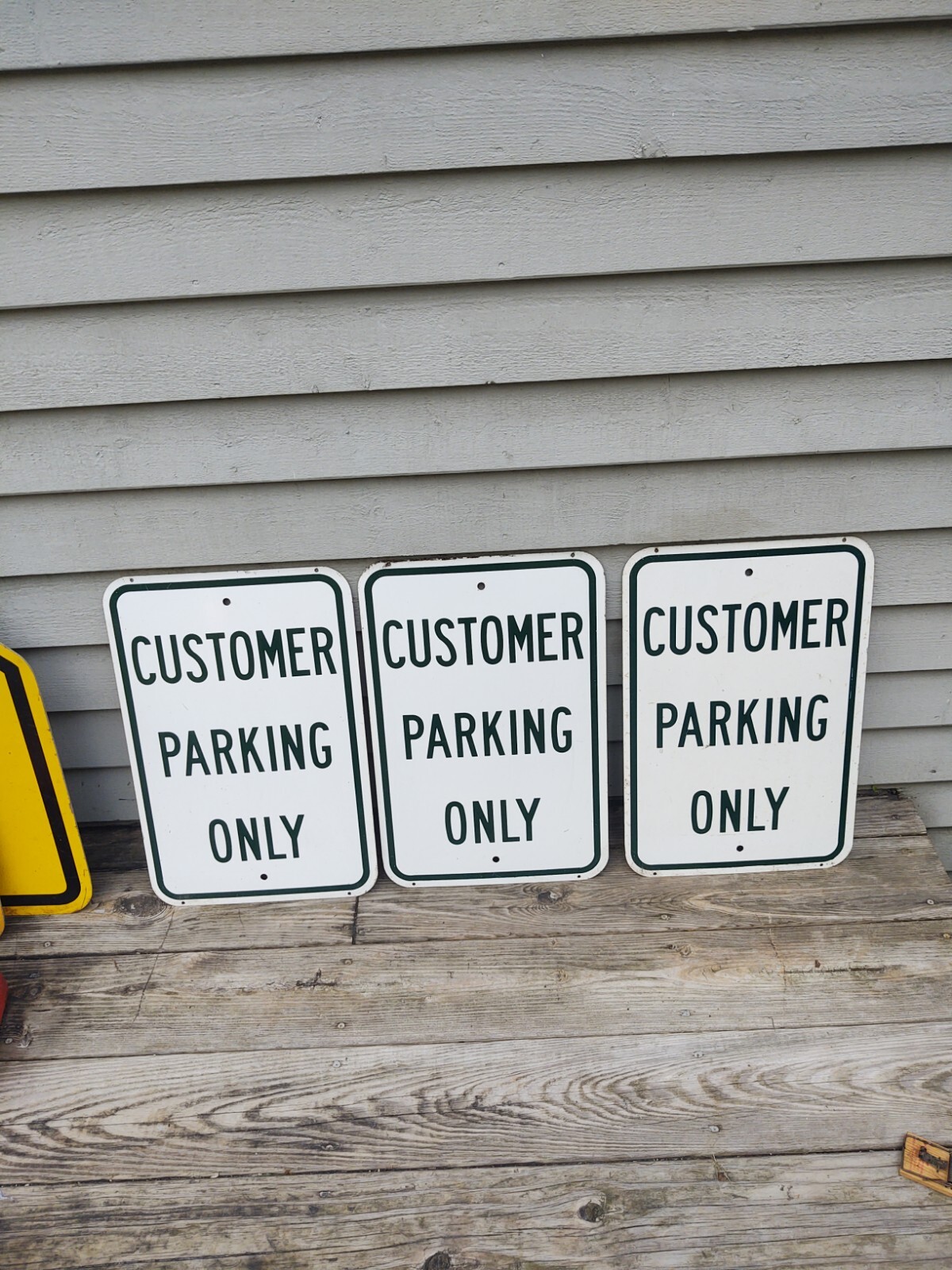 Three Metal CUSTOMER PARKING ONLY SIGNS