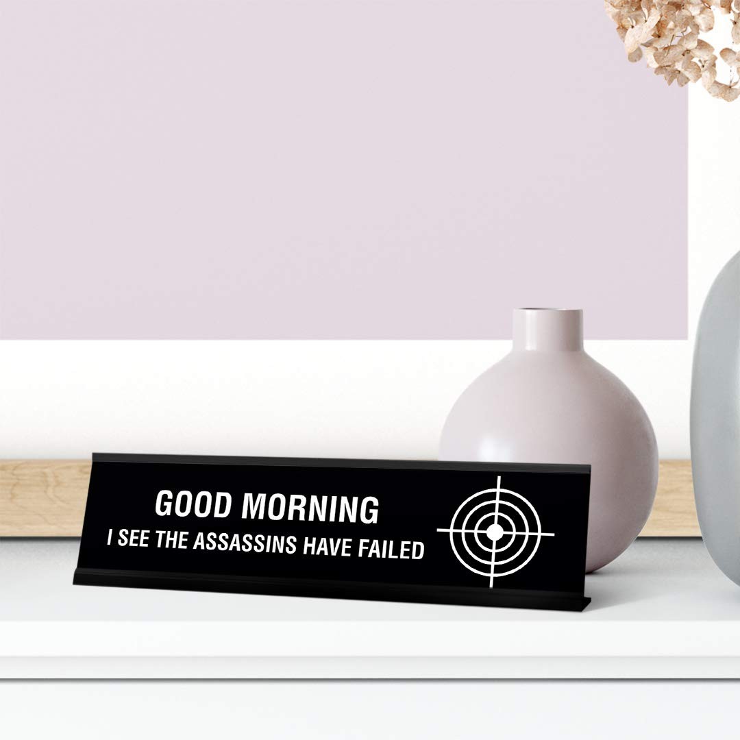 Good Morning I See The Assassins Have Failed Desk Sign, novelty (2 x 8″)