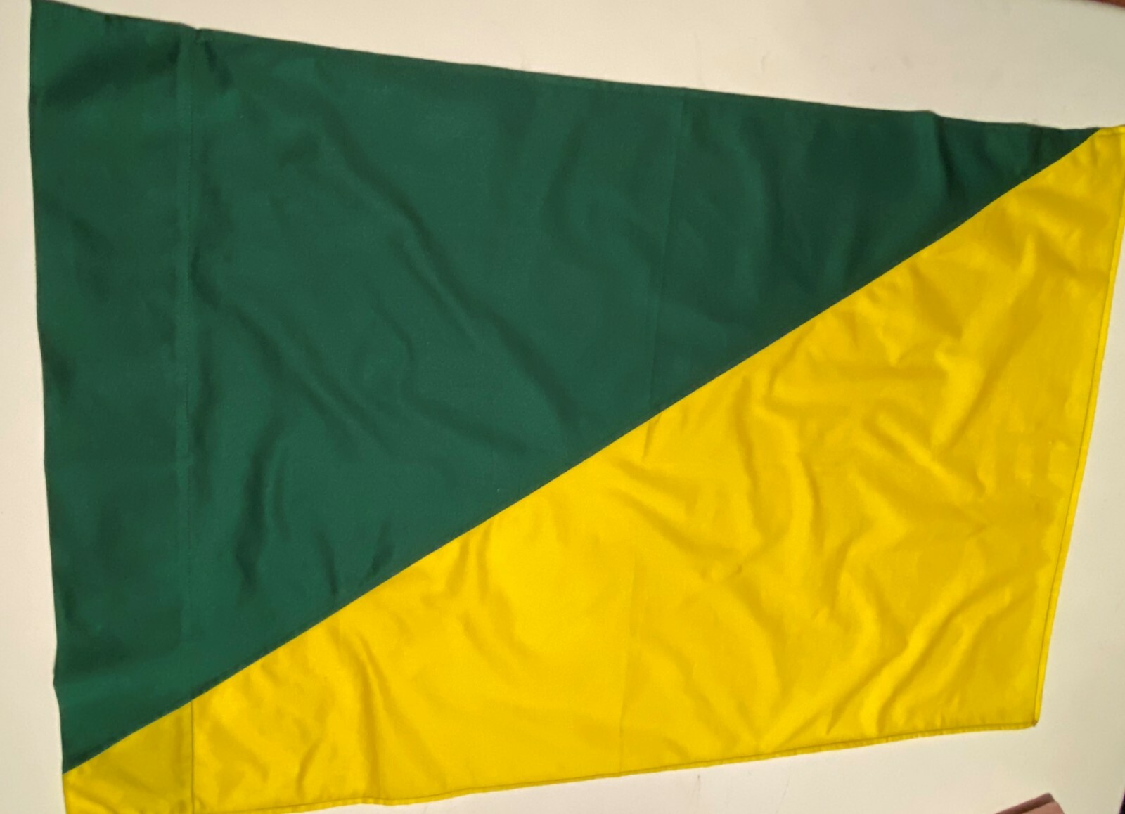 YELLOW AND GREEN TRIANGLE FLAG, WILL VERTICALLY HANG ROM A POLE, 25″ X 42″