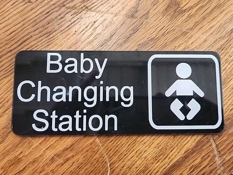 8×3 Inch Black New Baby Changing Station Sign with English Text and Symbol