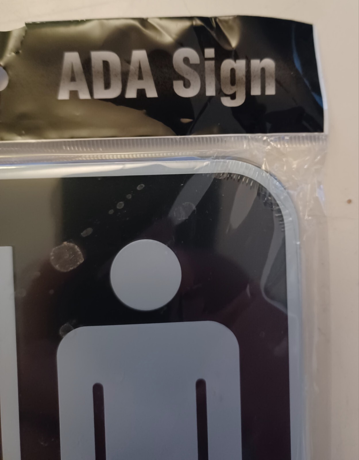 Cosco ADA RESTROOM Self Adhesive Sign with Braille 9″ X 6″