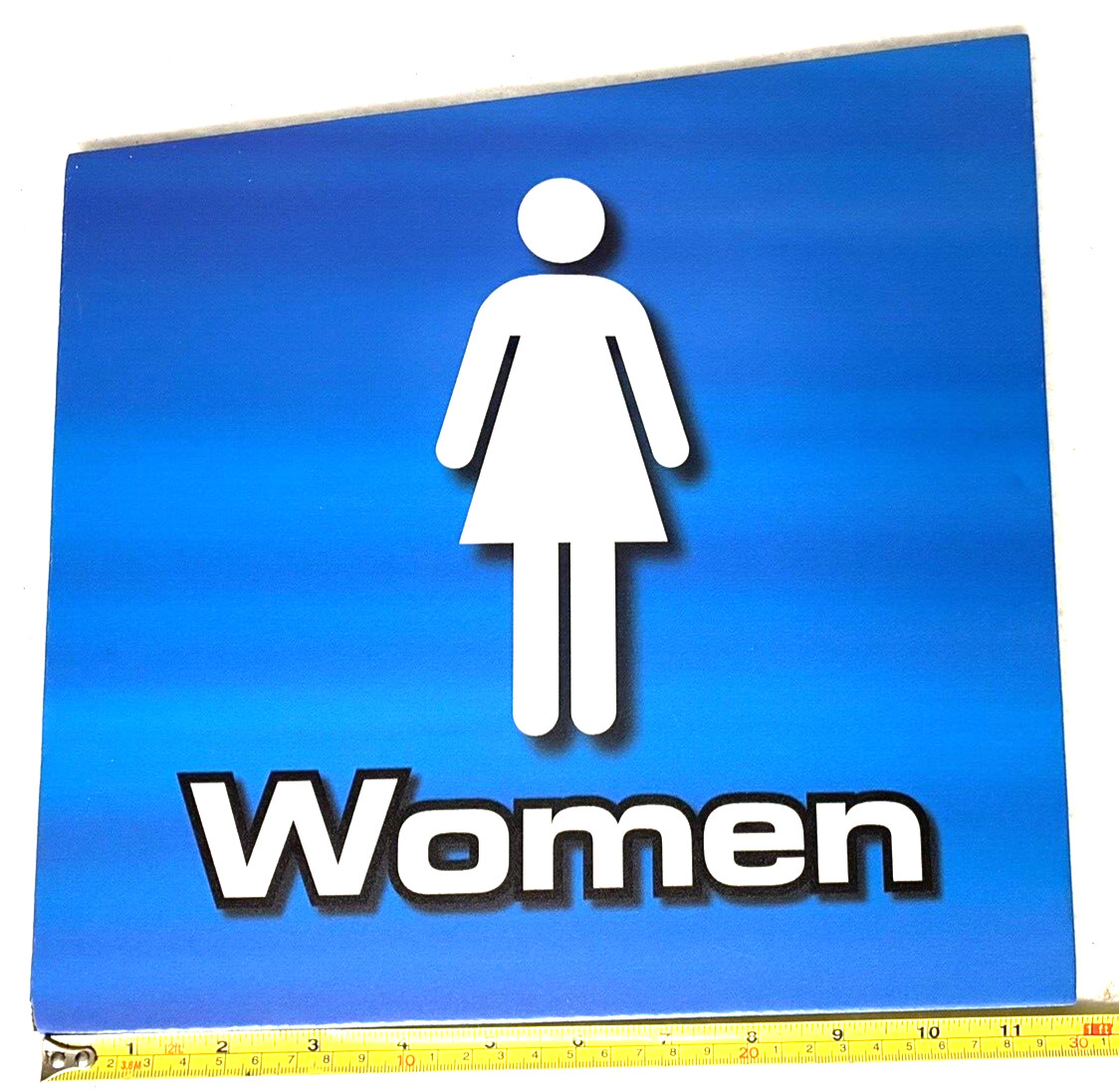 WOMENS RESTROOM SIGN,SELF-ADHESIVE,STICK,BLUE,TRAPAZOIDAL,PLASTIC FOAMCORE,NOS